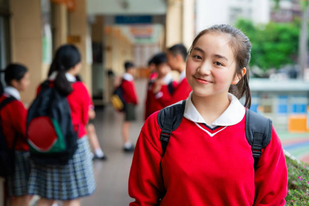 istock Female high school student standing in corridor 1157499005