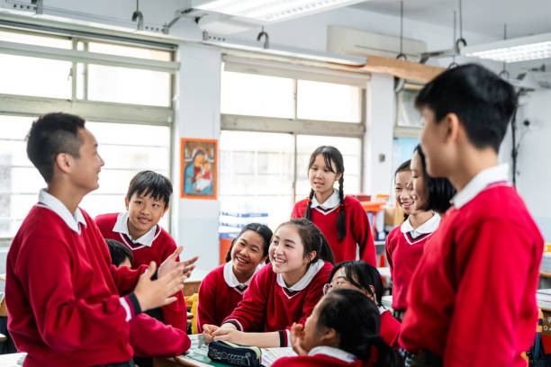 istock Happy high school students discussing in classroom 1157499174