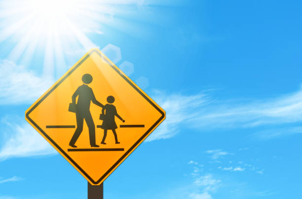 istock School zone warning sign on blue sky and sun light white clouds background. Copy space of transportation and travel concept. 1157499259
