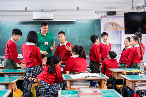 istock Teacher and students discussing in classroom 1157499303