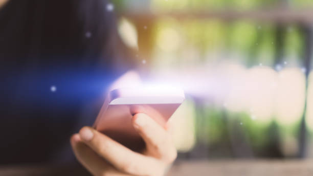 istock Woman hand using smart phone in cafe with green nature bokeh abstract background. Copy space of technology and business concept. Shallow depth of field. Vintage tone filter color style. 1157504248