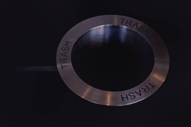istock Round metal engraved with the word TRASH. 1157505429