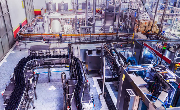 Bottling Plant in Africa Industry, Business, Factory, Bottling Plant - Bottles Filled with Fresh Drink Moving on a Conveyor Belt to the Packaging Section of a Factory. bottling plant stock pictures, royalty-free photos & images