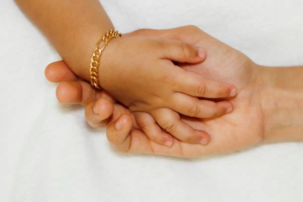 istock mother holding a baby's hand 1157509429