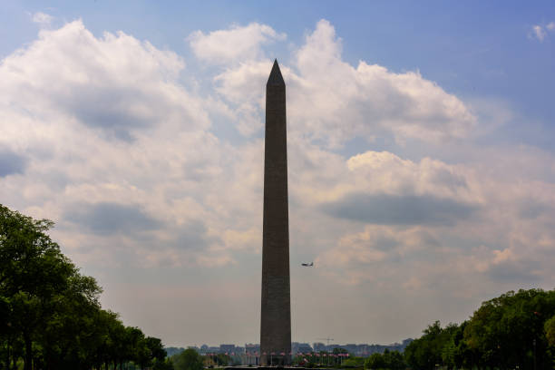 istock Close up Washington Monument with airplane in background 1157510471