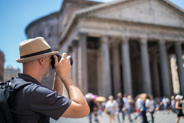 istock man during city break in Rome photographing pantheon 1157510976