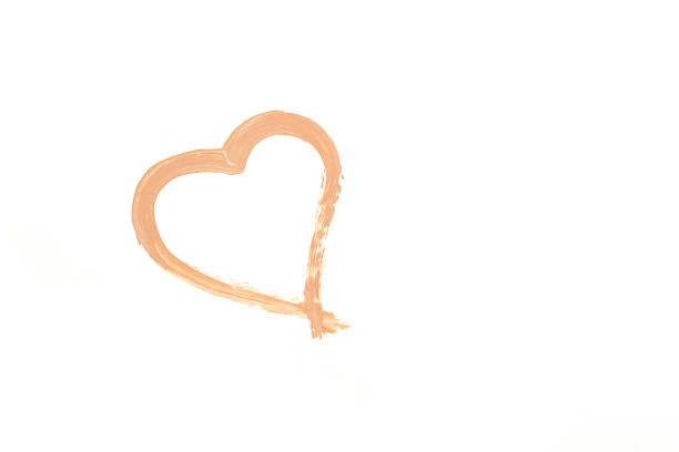 Close up of heart make from makeup foundation on white backgropund.