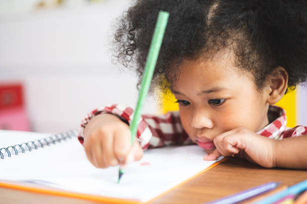 istock African cute kids studying  at home, kids education concept 1157512201