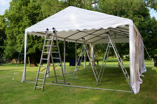 event tent set up  with ladders on the lawn in a park for a summer party or wedding event tent set up  with ladders on the lawn in a park for a summer party or wedding pavilion photos stock pictures, royalty-free photos & images
