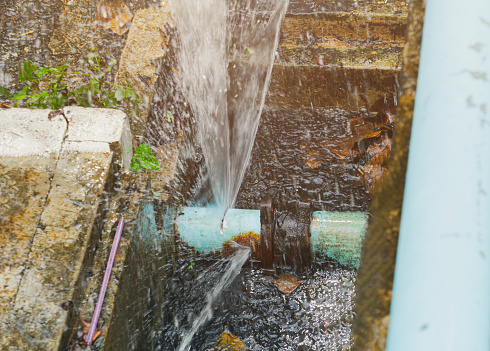 broken pipe in hole ditch at roadside and water Motion