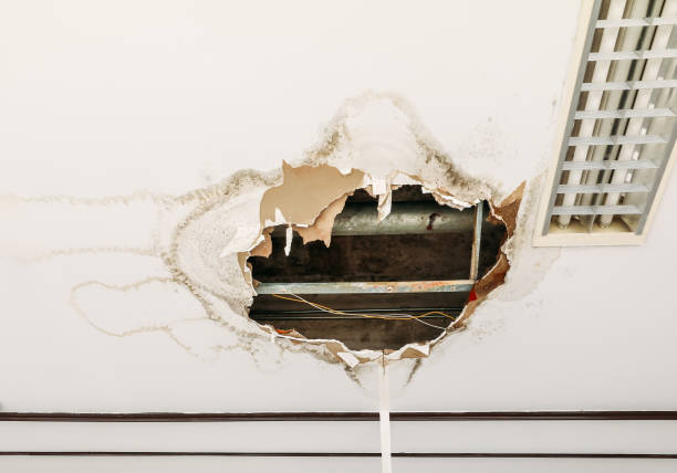 istock gypsum ceiling decay hole interior office building 1157518164