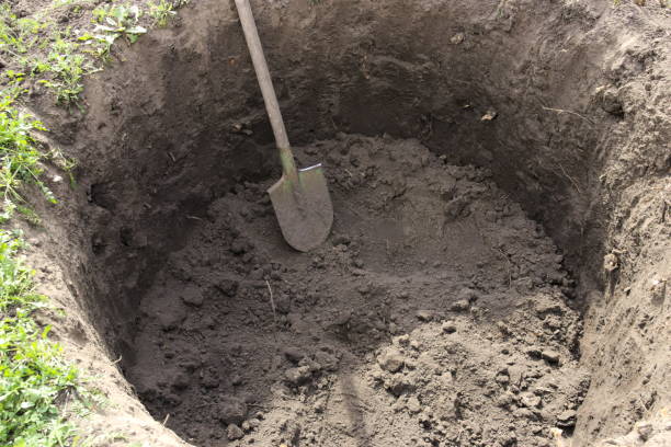 istock Deep pit in the ground. In the pit shovel. Digging a hole. 1157518181
