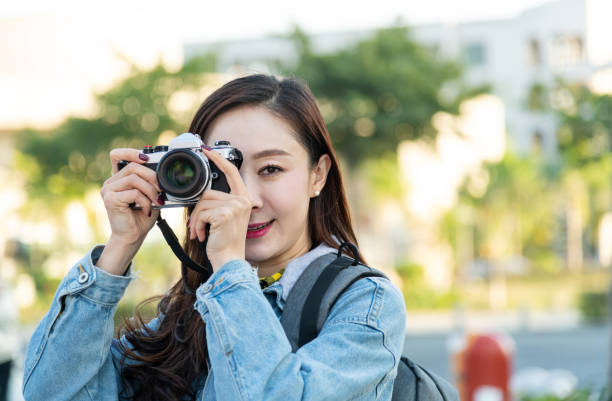 istock Women taking photos with a SLR camera 1157518341