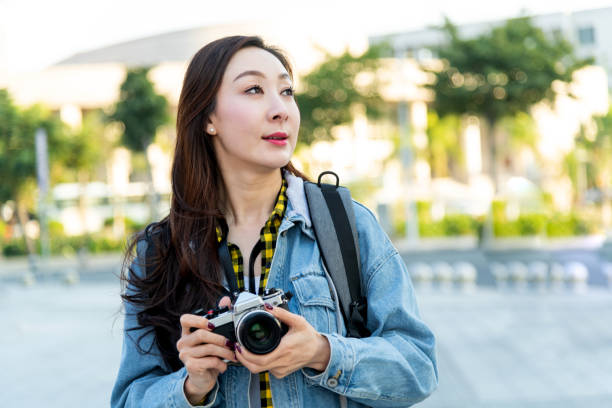 istock Women taking photos with a SLR camera 1157518395