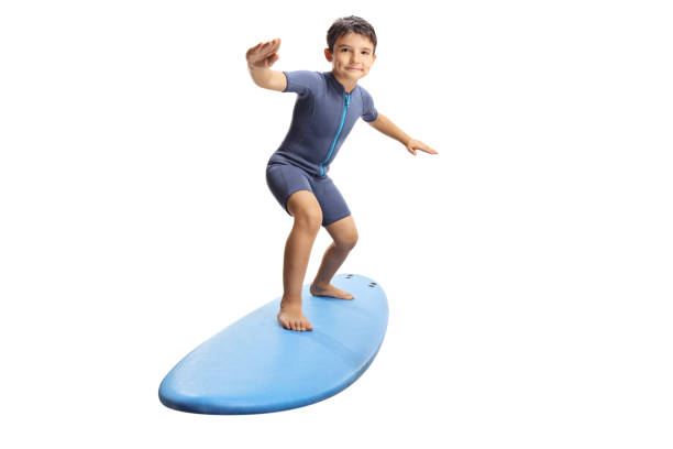 istock Little boy surfing on a surfboard 1157519628