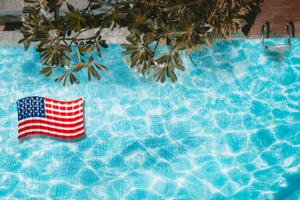 istock Pool float, ring floating in a refreshing blue swimming pool with palm tree leaf shadows in water. Top View 1157523147