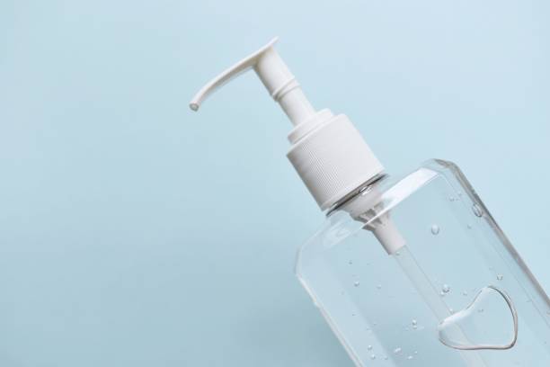 istock Close-Up Of Soap Dispenser Against Blue Background 1157525778