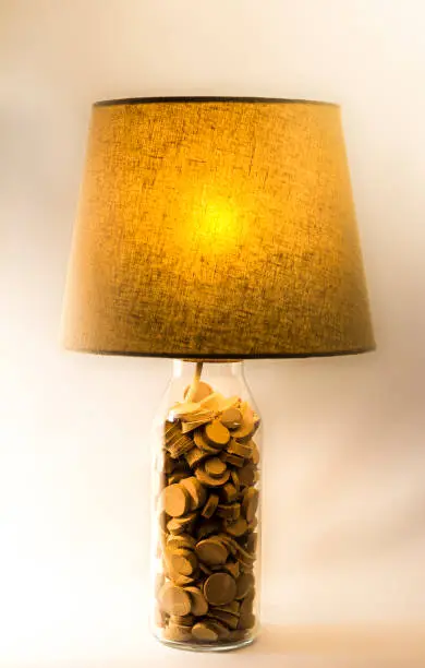 A handmade small table lamp with lampshade, connected to electricity / illuminated