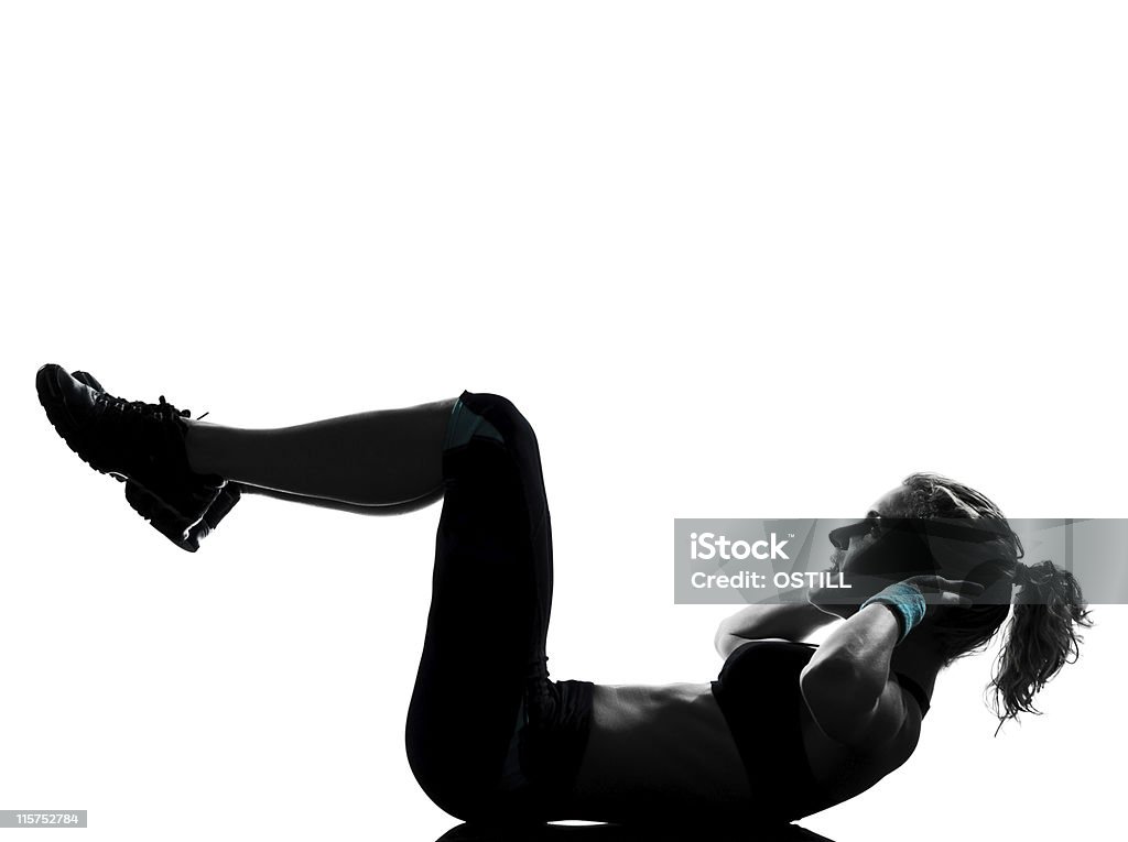 Young woman with ponytail in fitness posture one woman exercising workout fitness aerobic exercise abdominals push ups posture  in studio   on white background 25-29 Years Stock Photo