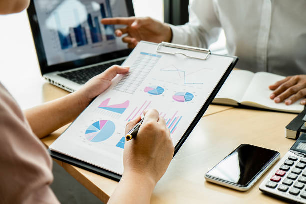 istock Business adviser analyzing financial figures denoting the progress Internal Revenue Service checking document. Audit concept 1157532213