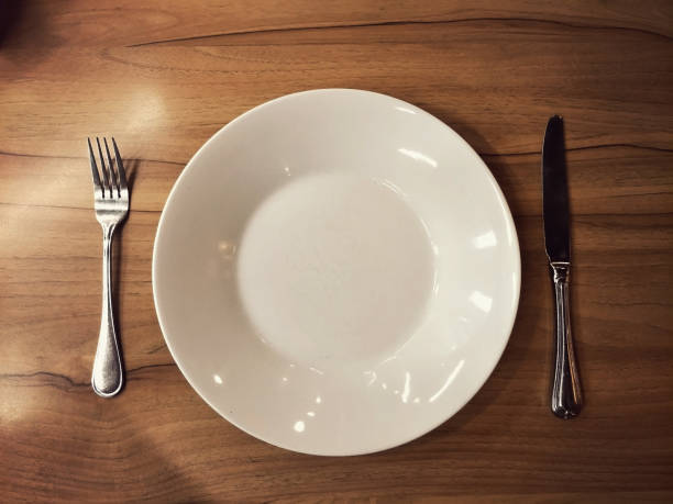 istock empty eating set dish knife and fork on wooden table photo from above top view 1157532224