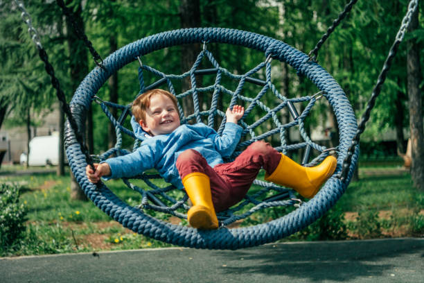 Cute child swinging on playground
