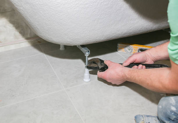 istock Bath installation. Worker is making fastener with wrench. Maintenance repair in the flat. Renovation process. 1157534935