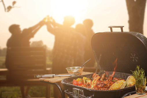 Group of six teenagers having fun on barbecue party