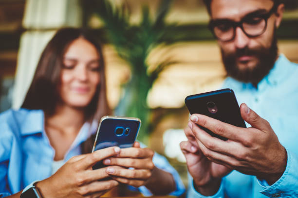 istock Selective focus on male and female hands holding smartphone devices and messaging with friends ignoring live communication, man and woman using digital gadgets for updating profiles in social networks 1157539832
