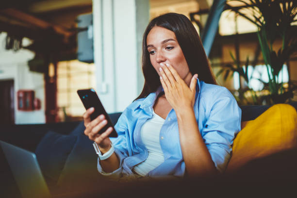 istock Shocked hipster girl feeling excited from received email about promotion discount using 4g connection on modern smartphone device, amazed woman reading news via cellular with expression on face 1157539906