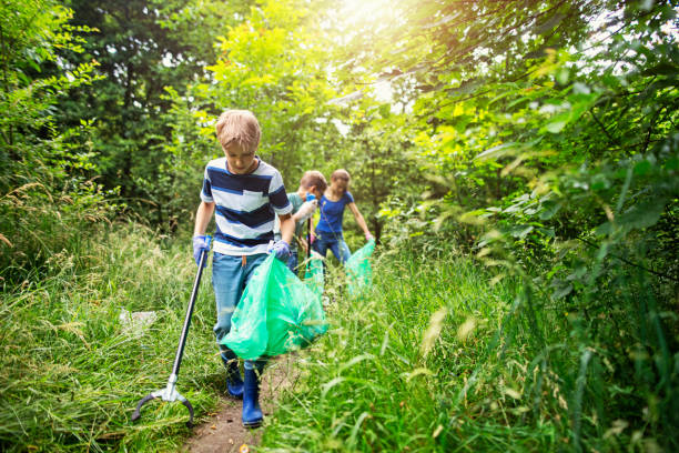 istock Kids cleaning up the forest 1157540403