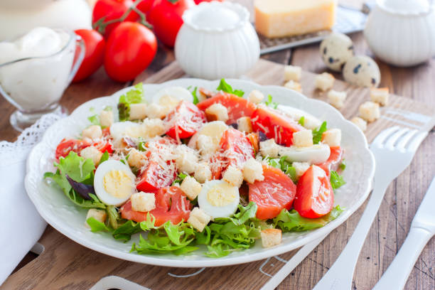 istock Caesar salad with red fish on the wooden table, horizontal 1157541873