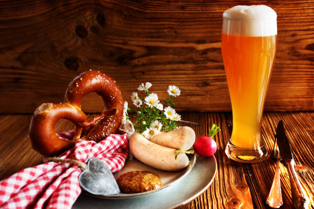 Bavarian specialties on rustic wood Bavarian specialties fresh beer with salt pretzel and white sausage on rustic wood for the Beer Fest weisswurst photos stock pictures, royalty-free photos & images