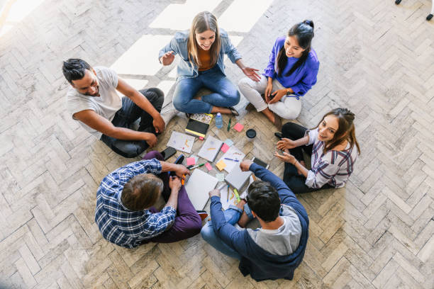 istock overhead view on young people sitting in a circle on floor 1157546703