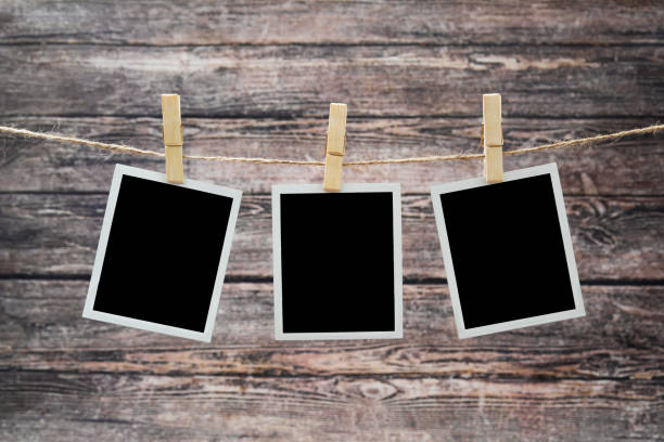 istock photos hang on a rough rope, fixed with wooden clothespins 1157547430