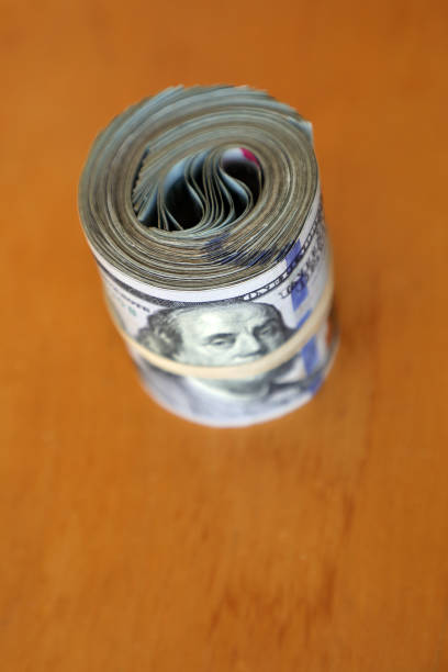 istock bundle of rolled up and rubber banded American one hundred dollar bills 1157549893