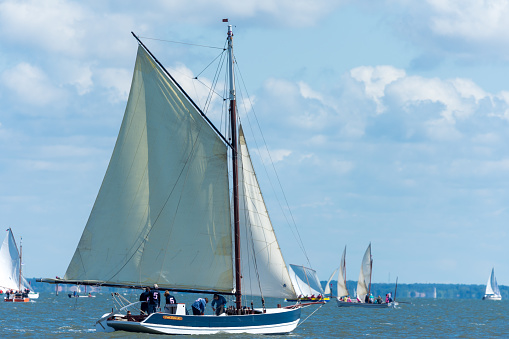 Andernos, France - June 15, 2019: Every year in June, a friendly regatta is organized off Andernos, near Cap Ferret, to launch the summer season. It brings together the small sailboats, the old riggings, as well as the traditional Pinasses, these small sailing boats typical of the Arcachon basin.
