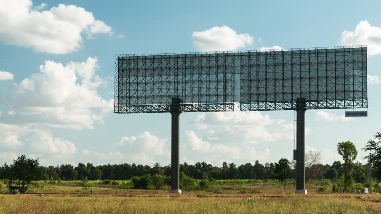 Back structure of large billboards on meadow. 4K Time lapse