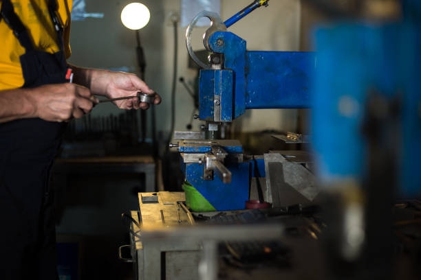 istock Mechanic with protection is  concentrated on drilling 1157555063