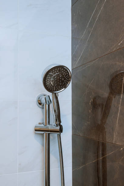 istock New shower head in the bathroom, close-up wall 1157555716