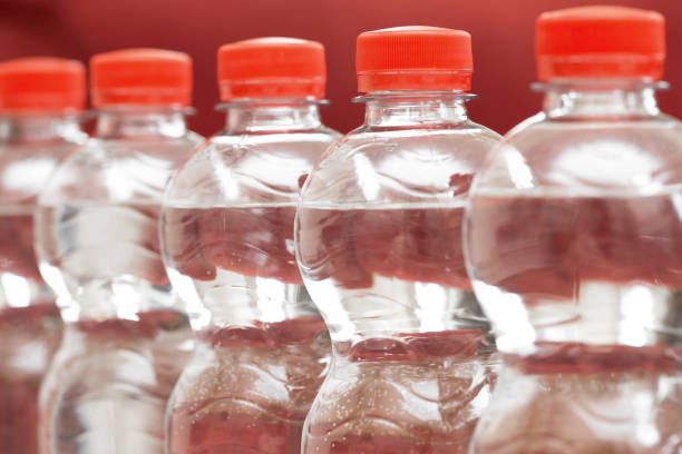 istock Row of water bottles, bubbling spa red, recycling environment concept 1157557314