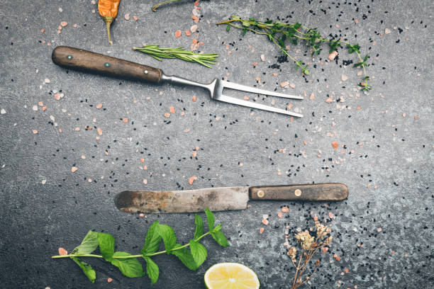 Mixed spices and herbs on black stone table top view