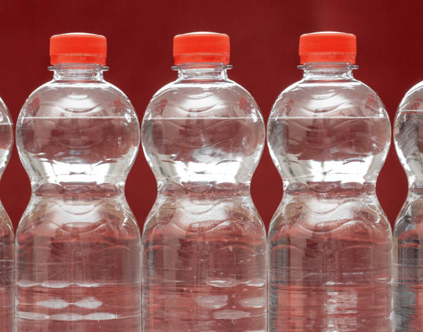istock Row of water bottles, bubbling spa red, recycling environment concept 1157558001