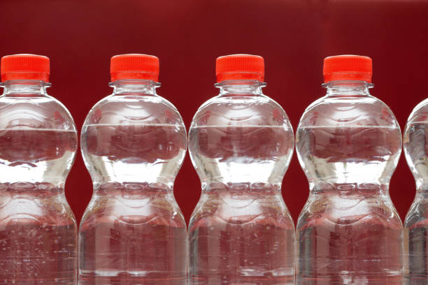 istock Row of water bottles, bubbling spa red, recycling environment concept 1157558073
