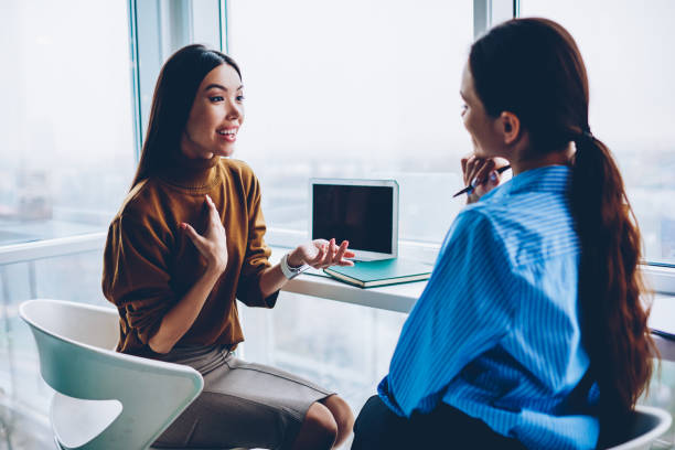 istock Surprised female share information with colleague during working day in office discussing success in business project,emotional woman speaking about conmany good news sitting with friend coworker 1157559518