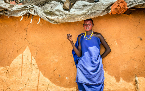 African woman wearing traditional clothes in Masai tribe Masai Village, Kenya - October 11, 2018: Unindentified african woman wearing traditional clothes in Masai tribe, Kenya kenyan culture stock pictures, royalty-free photos & images