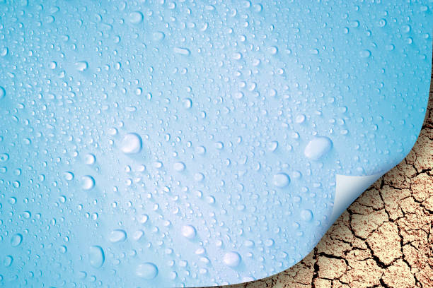 istock raindrops covered wet surface curled up from corner over cracked dry land 1157563606