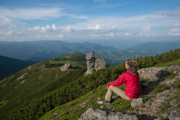 istock Woman contemplates mountains landscape 1157564449