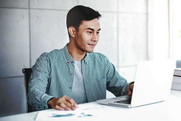 istock Happy Young Businessman Working on Computer Laptop in Office 1157564891