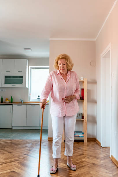 istock Senior Woman Walking With Cane 1157567010
